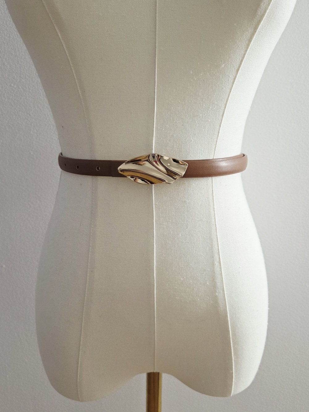 Brown belt with gold buckle